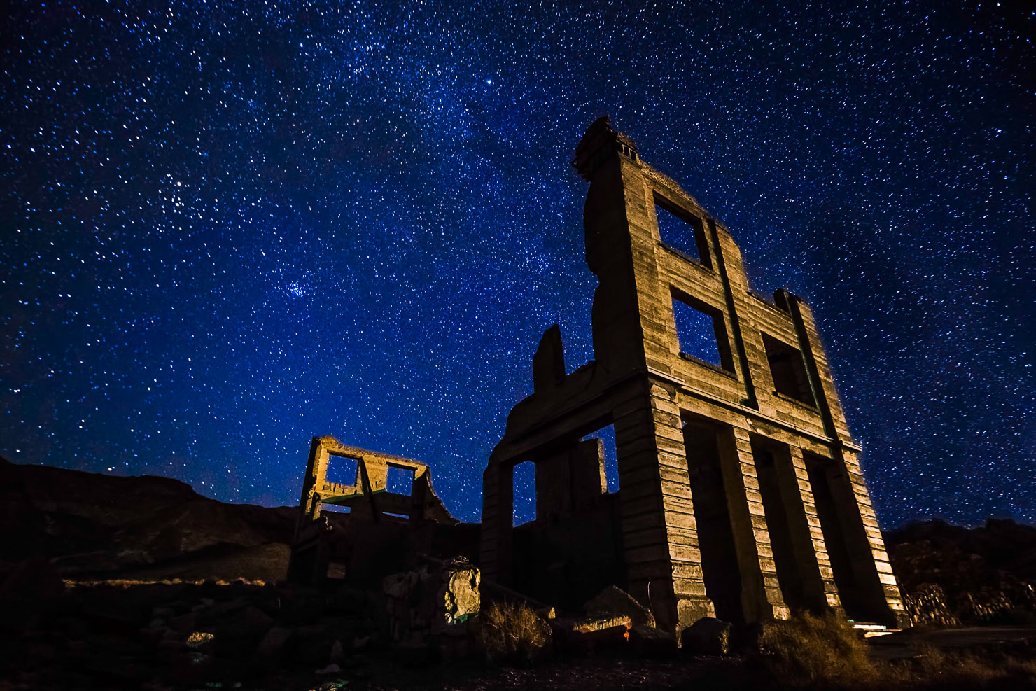 Rhyolite ghost town ruins at night under Milky Way, Nevada
