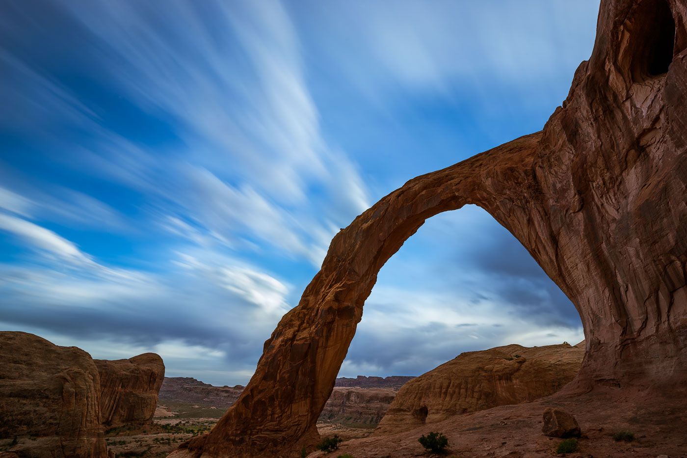 Corona Arch with streaking clouds on long exposure, Moab Utah